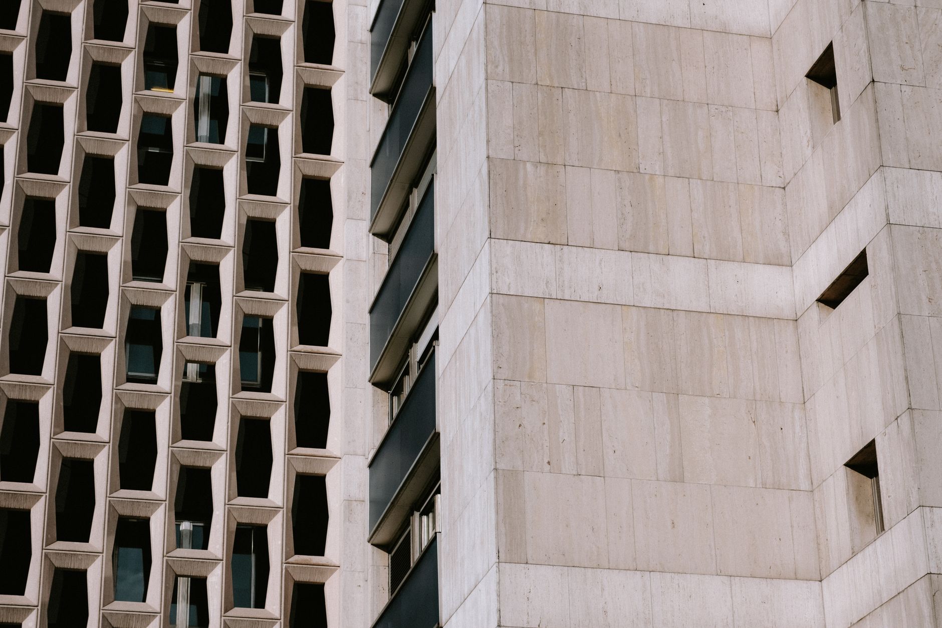 Detail of a facade in fluted precast concrete and dark aluminium