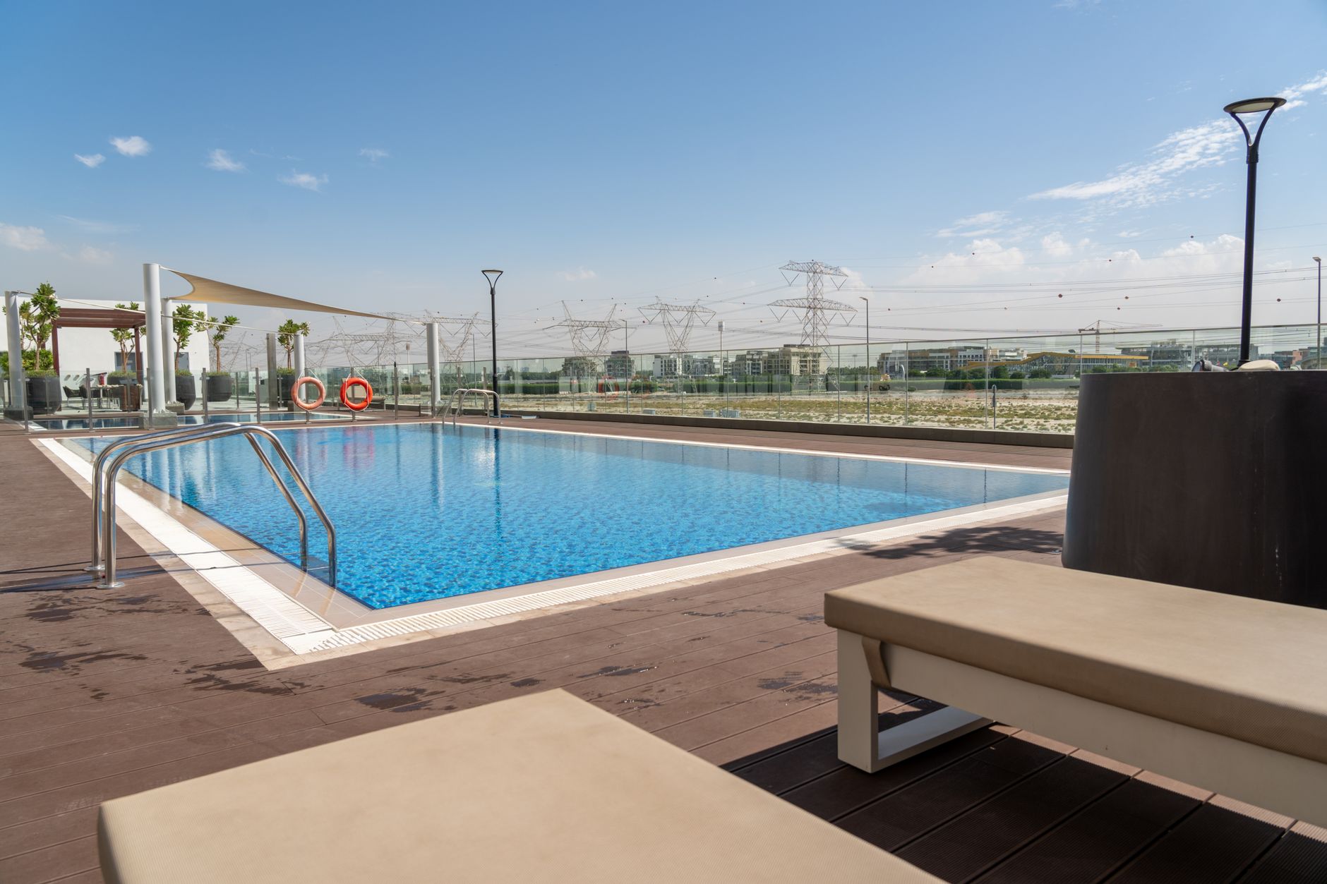 Landscaped podium deck with a lap pool and cabanas