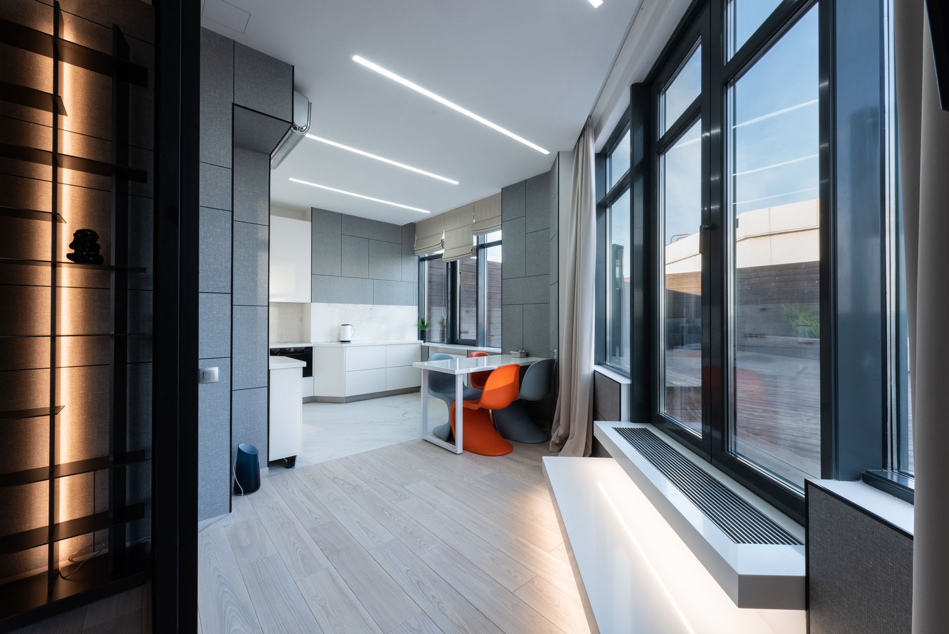 Show-unit living room with floor-to-ceiling glazing and timber floors