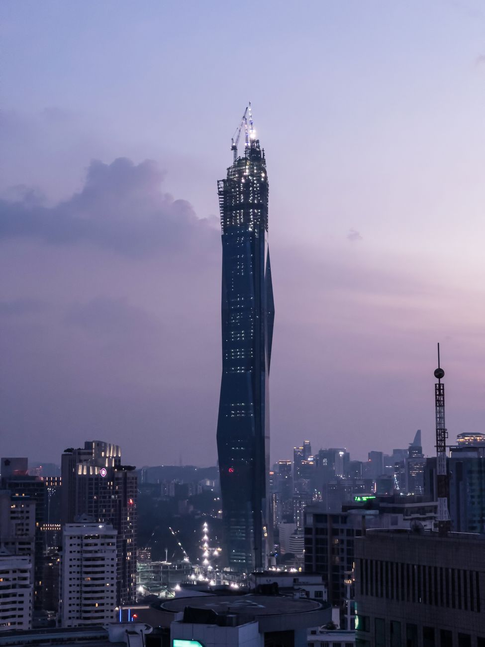 Tower cores rising against the Kuala Lumpur skyline at dusk
